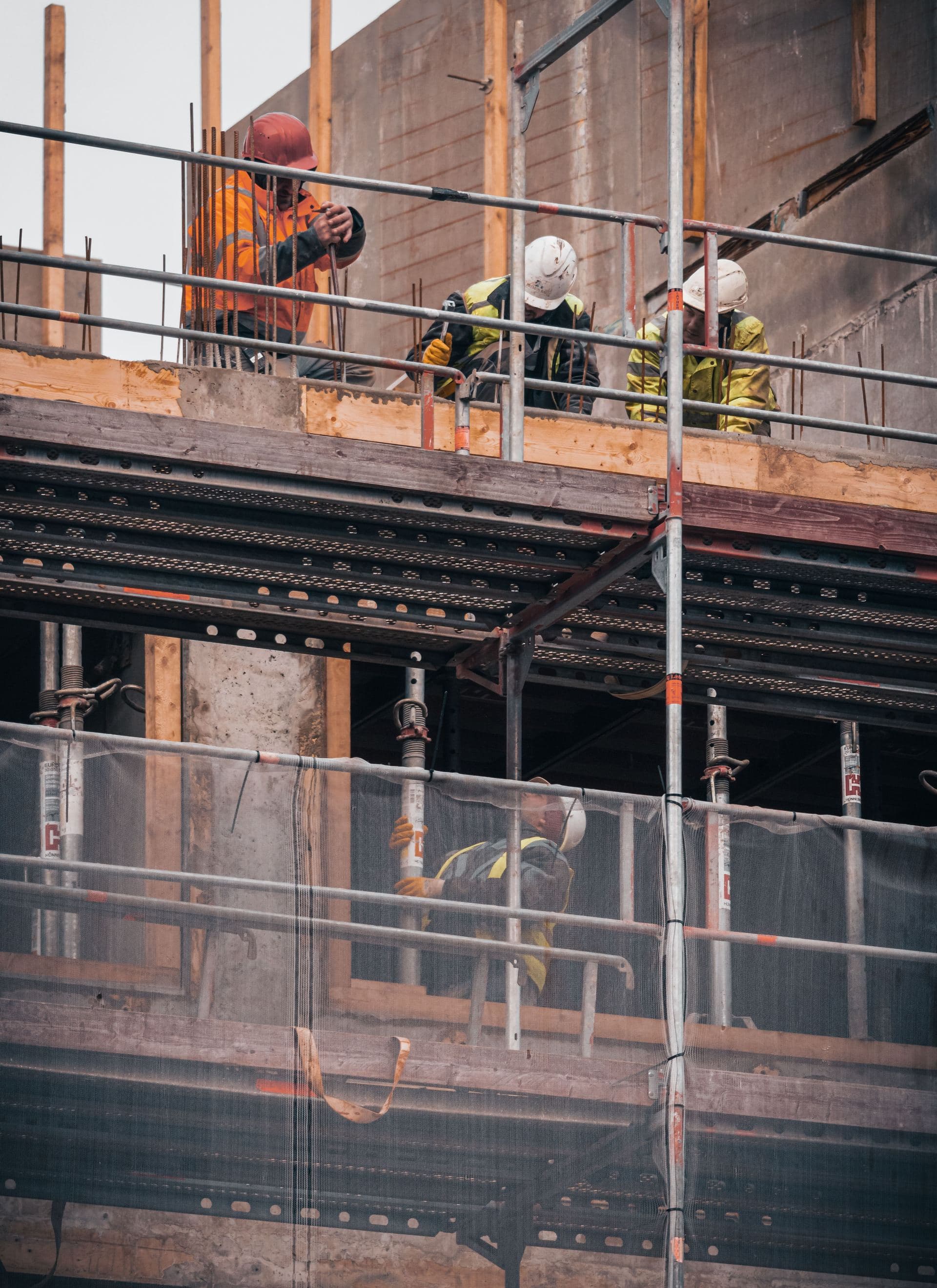 Construction crew working on structural concrete and rebar on a multi-story building